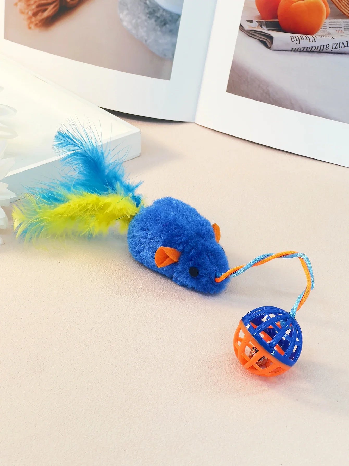 A Stuffed Mouse with A String Sounding Bell Ball
